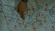 Mohnke points at a map where Tiergarten is, using 2 fingers.