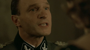 Fegelein tells Eva to leave her party. "It's for your own safety."