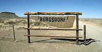 Sign to Burgdorf's secret farm in Namibia. The additional S was a result of him making it while drunk.