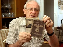 A man (maybe son or not) holding Harald's documents.
