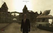 Agent 47 in front of the Southland Amusement Park.