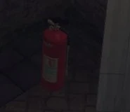 The fire extinguisher.