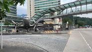 Main entrance to Cathay City, with a Douglas DC-4 "Niki" (VR-HDA) replica displayed beside the bus stop and signage