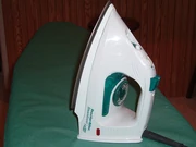 an iron heating up on an ironing board