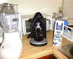 some small appliances: blender, coffee maker, toaster, microwave
