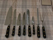 knifes, sharpening steel and cooking or serving fork
