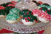 Sugar plum cookies with different decorative sprinkles, including some with green and red large granual sugar sprinkles.