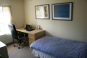 desk, chair and bed in the bedroom