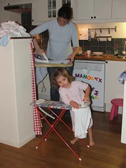 The two of us are busy ironing.  Some play helps us learn how to do household chores.