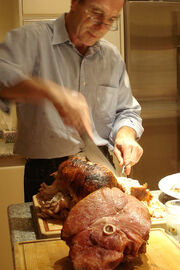 Slicing the turkey in preparation for a meal.