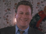 John Heard smiles