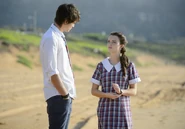 Evie talks to Josh at the beach