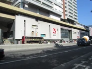 View of eastbound stop from the opposite side, with the mall still named Lung Cheung Mall at that time (December 2010)