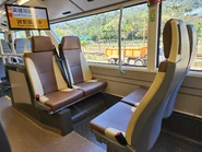 Upper deck backward facing seats, with a beige railing installed on the backward-facing seat near the corridor afterwards (Pictured is V6X129/YE1070)