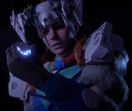 Aloy holding the Master Override.[1]
