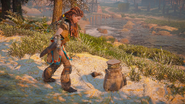 Aloy examining the dropped supplies.