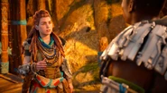 Aloy talking to Varl outside the Main Embrace Gate.[1]