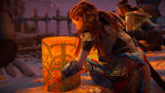 Aloy lifting her lantern into the air.[3]