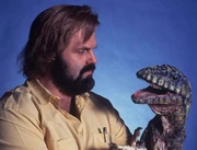 Promotional photo of John Carl Buechler with his Deinonychus puppet.