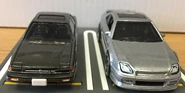 A front view of the 2017 Tomica Limited Vintage NEO ’85 Honda Prelude 2.0 Si (1/64, left) and 2021 Hot Wheels ’98 Honda Prelude metalflake silver (car culture, modern classics, right).