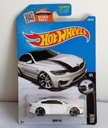 BMW M4 2016.jpg (767 KB) 2016 - Carded sample of white 2016 BMW M4 showing the hood art not present on the model.