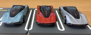 A back view of the Hot Wheels McLaren Speedtail from left to right: metalflake light blue, metalflake orange, metalflake gray