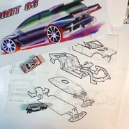 Original desk photo by designer Mark Jones (2002), featuring the Flight '03 colored concept rendering, "MY TUNA 3X" technical blueprints, and early prototypes.