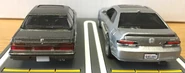 A back view of the 2017 Tomica Limited Vintage NEO ’85 Honda Prelude 2.0 Si (1/64, left) and 2021 Hot Wheels ’98 Honda Prelude metalflake silver (car culture, modern classics, right).