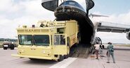 Military Airlift Command C-5 Galaxy loads a prototype of the USAF P-15 Truck, Airport Rescue Fire Fighting (ARFF) in an airlift test, Oshkosh, WI, 30 June 1977