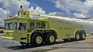 A firefighter wearing a proximity suit operates the high pressure water cannon of a US Navy P-15 Truck, Airport Rescue Fire Fighting (ARFF), NAS, Roosevelt Roads, Puerto Rico, 1 December 1986