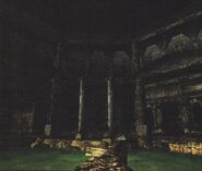 The inside of the colosseum. The fallen pillars create a bridge over the body of water.