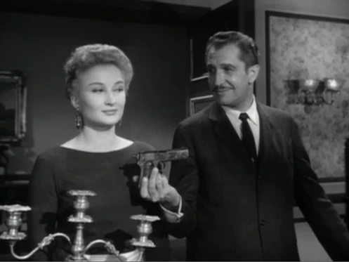 Loren hands a Colt Model 1903 Pocket Hammer to his wife Annabelle.