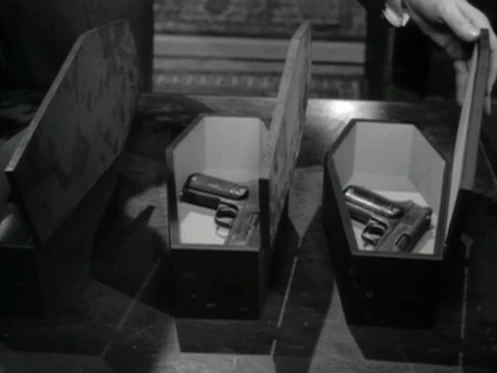 The Colt Model 1903 Pocket Hammer Pstol "party favors" in their miniature coffins.
