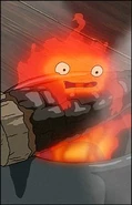 Calcifer being lifted out of a cup.