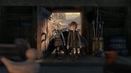 Hiccup and Astrid walking into a house