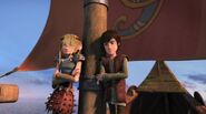 Hiccup and Astrid leaning against the post