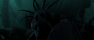 Valka uses its staff to command the dragons to light the cave.gif
