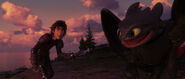 Hiccup about to toss his prosthetic leg off a cliff