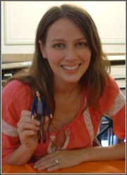 Amy Acker holding a figure of Fred from Angel