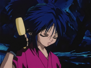 Machi combs her hair while watching Hisoka vs. Gon