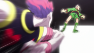 Hisoka strikes Gon with his elbow