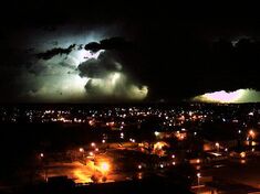 The tornado damaging a powerline after nightfall