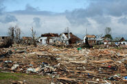 Damage to a neighborhood of well-built homes leveled at high-end EF4 strength.