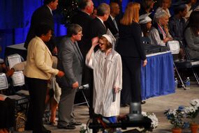 My Uncle Ron took this...OMG...I love this! My cap was falling off ONSTAGE! Shows how much of a klutz I am! Bahaha typical me! Look at the reactions of the 2 people there: You ok dere? LOL!