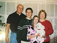 This is *not* a recent picture of his family, but it is cute and shows the previous family dog, Muffy. Now they have Sandy. So it's John's dad, John, his sister Amy and his mom. They all basically look like that now except older...and Muffy is now Sandy LOL.