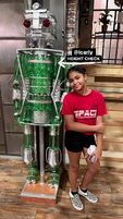 Jaidyn next to Bottle Bot on set