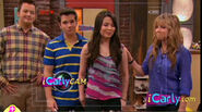 Sam rests a hand on Carly's shoulder as she tells Col. Shay bye. Carly briefly looks at Sam