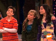 Sam with an arm around Carly, gloating at Nevel