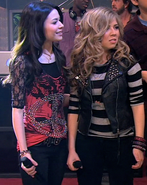 Carly puts her arm around Sam.