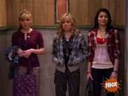 Carly and Sam standing close together on the elevator